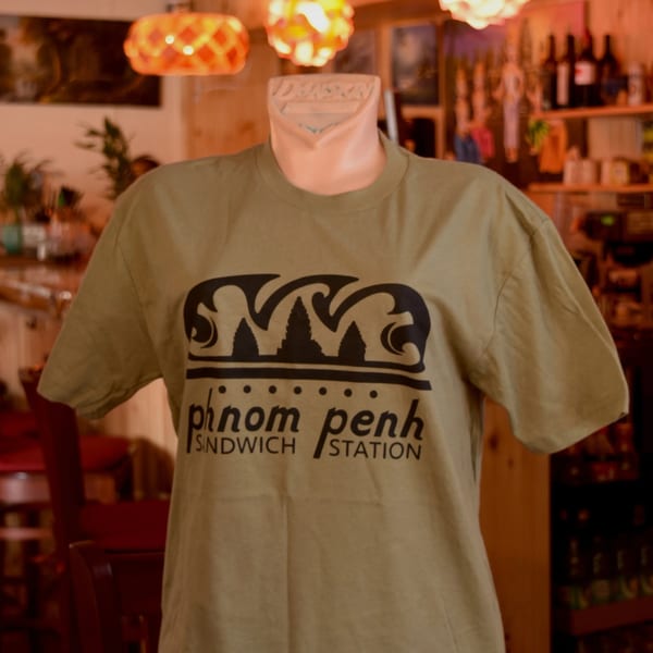 A mannequin displays a khaki Phnom Penh Sandwich Station t-shirt with a black logo.